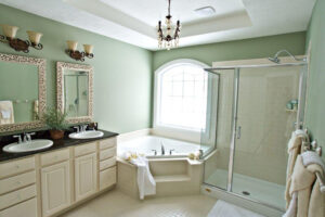 green bathroom with garden tub and jack and jill sink