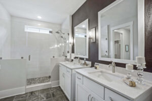 upscale white jack and jill bathroom with brown walls