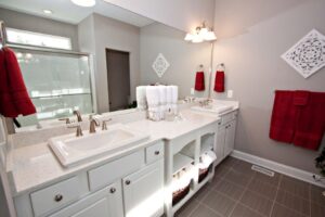 white bathroom with deep red towels