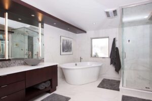 modern bathroom with wooden cabinets, bathroom, and glass-doored shower