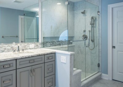blue bathroom with glass-doored shower